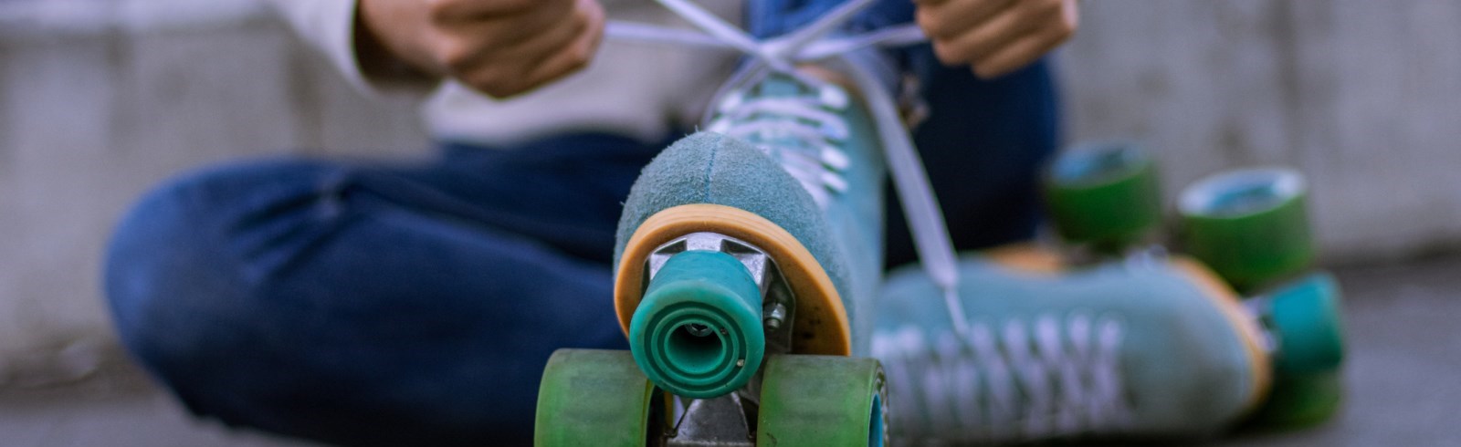 person tying up their roller skates