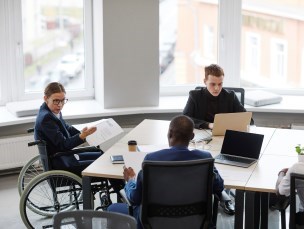 Volunteers sitting at a table in a meeting