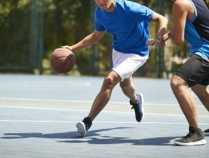 person playing basketball outdoors